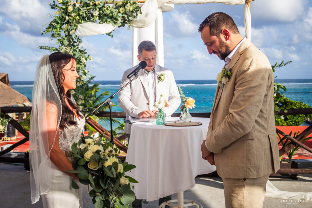 A couple stands together with the minister who married them on the scenic rooftop of La Sirena Puerto Morelos, home of Let's Marry in Mexico.