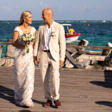 A newly married couple stroll down the iconic Puerto Morelos pier after their wedding ceremony.