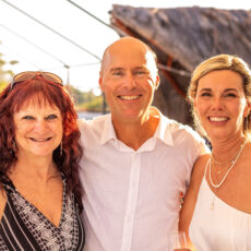 The bride and groom enjoy the rooftop at La Sirena with one of their female guests.