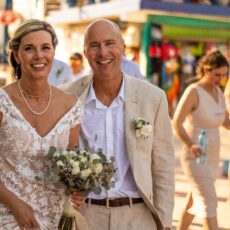 Newlyweds taking wedding photos on the streets of Puerto Morelos between their wedding ceremony and wedding reception organized by Let's Marry in Mexico.