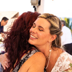 Bride hugging a loved one after the wedding ceremony at La Sirena Puerto Morelos.