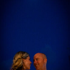 A newlywed couple shares a romantic moment under a full moon on the rooftop at La Sirena Puerto Morelos.